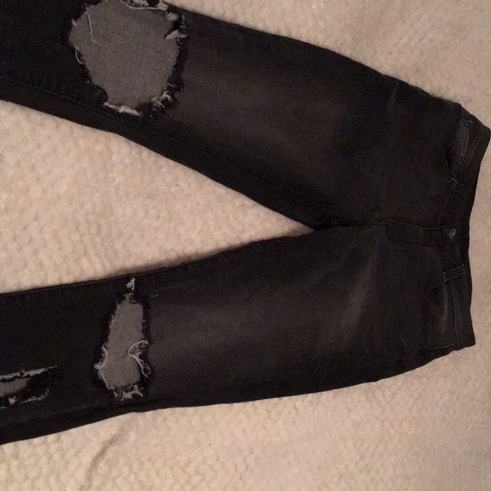 Arizona black jeans with cuts in knee and calf.